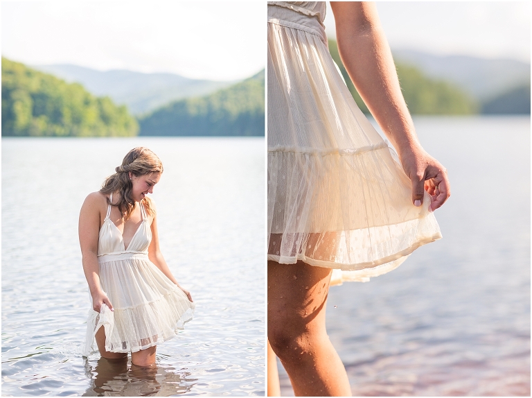 Senior photos of a girl in a white dress in a field by Switzer Lake with a mountain view taken by a Virginia graduation photographer