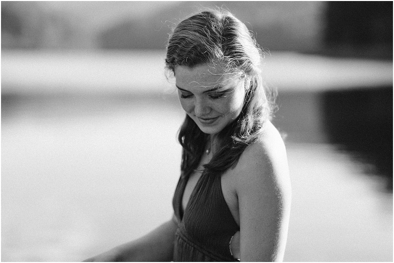 Switzer Lake senior photos of a girl in a purple dress in a lake with a mountain background taken by a Virginia portrait photographer