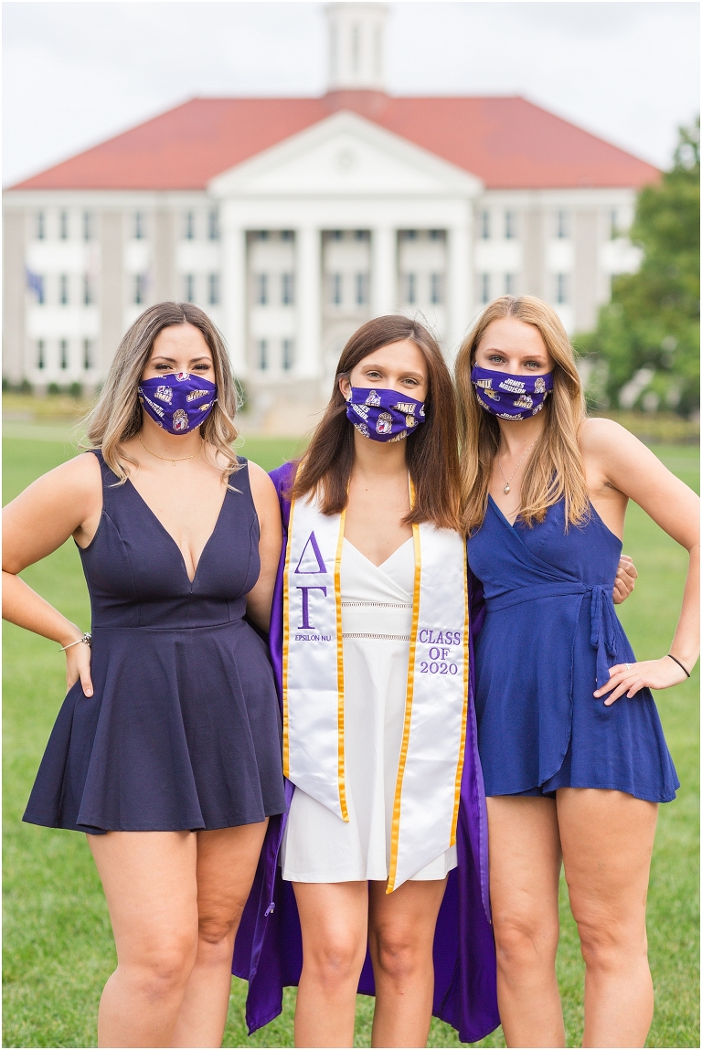 JMU senior and friends pose on the JMU Quad during photoshoot while wearing JMU masks.