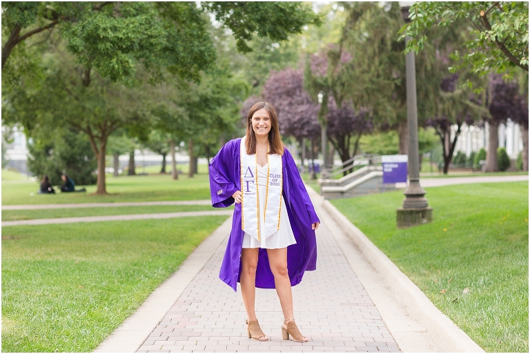 JMU senior posing on the Quad during senior photoshoot.
