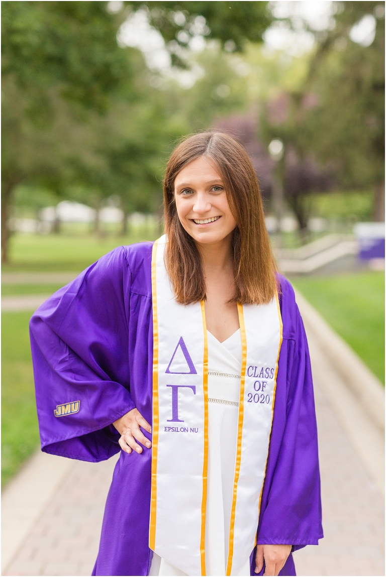 JMU senior posing on the Quad during senior photoshoot.