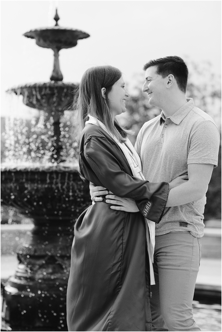JMU senior and her boyfriend pose at the fountain while hugging each other.