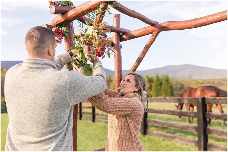 Decorating the arbor with flowers for a Virginia vow renewal and anniversary session in the autumn mountains