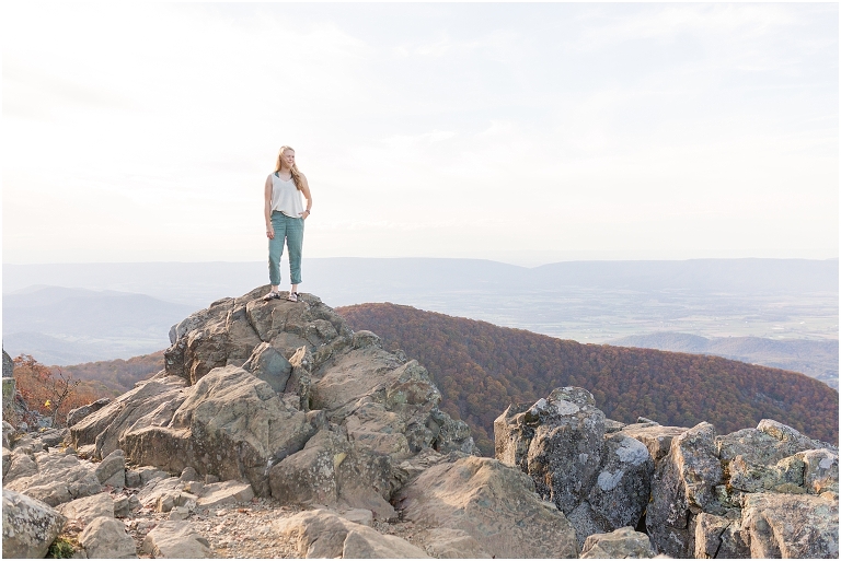 Sunset Hawksbill Summit Skyline Drive senior session with fall foliage and rolling clouds