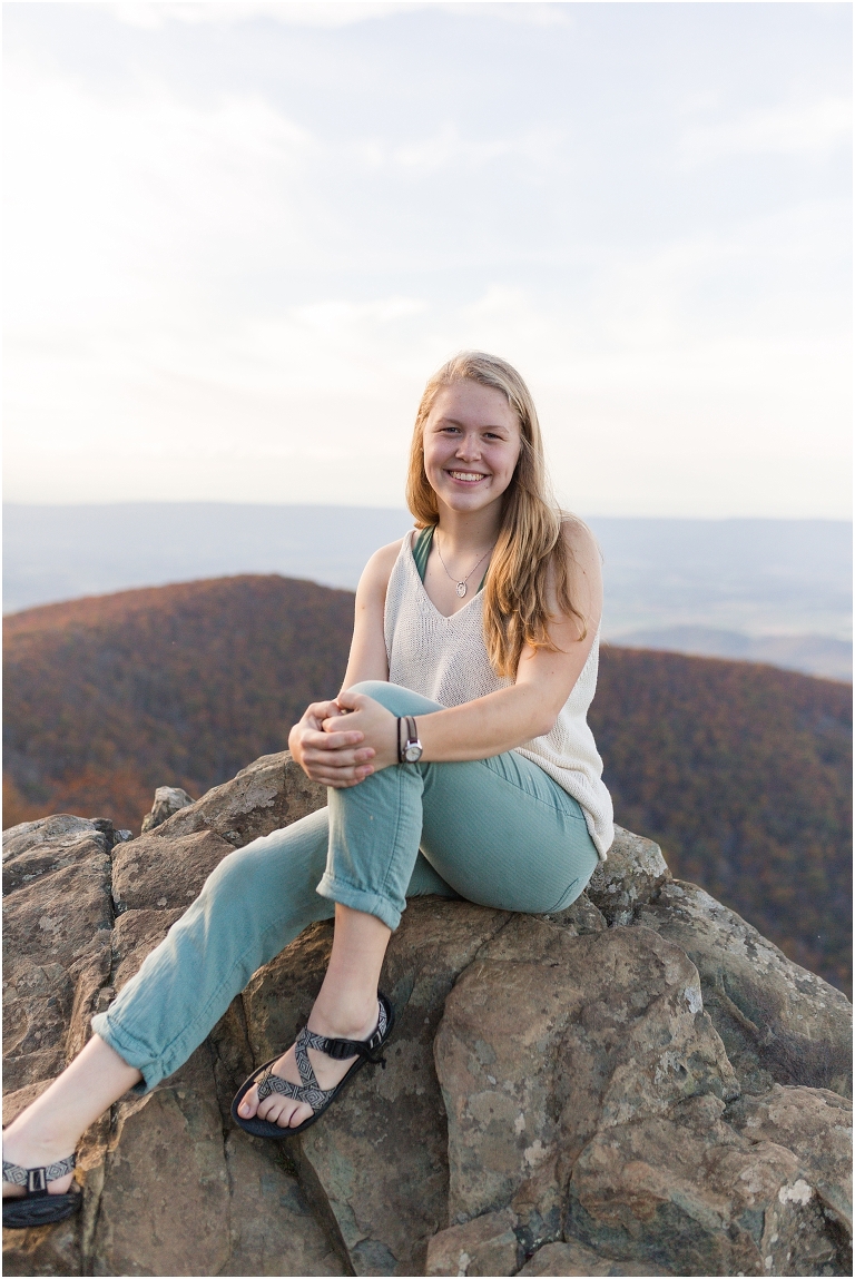 Sunset Hawksbill Summit Skyline Drive senior session with fall foliage and rolling clouds