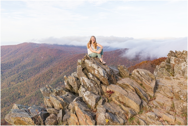 Sunset Hawksbill Summit Skyline Drive senior session with fall foliage and rolling clouds