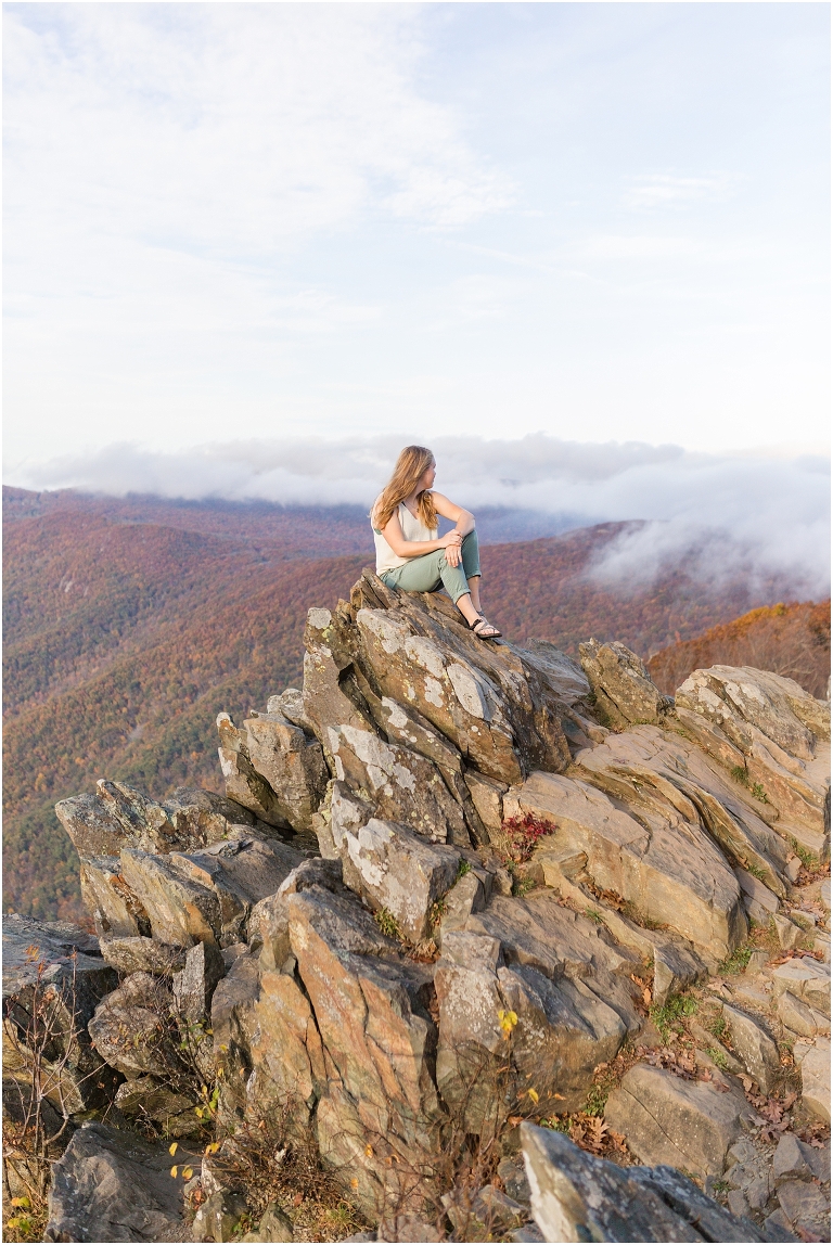 Sunset Hawksbill Summit Skyline Drive senior session with fall foliage and rolling clouds
