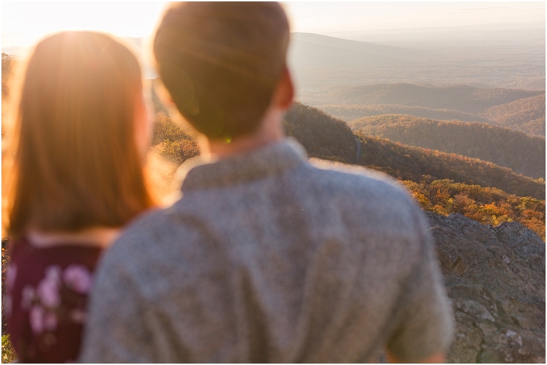 Couple at Humpback Rocks during sunset, surrounded by fall colors and blue sky.