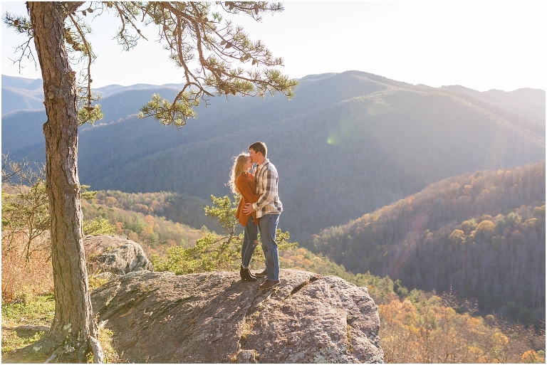 Blue Ridge engagement session with fall foliage and blue skies surrounding them.  Blue Ridge Parkway in Virginia. 