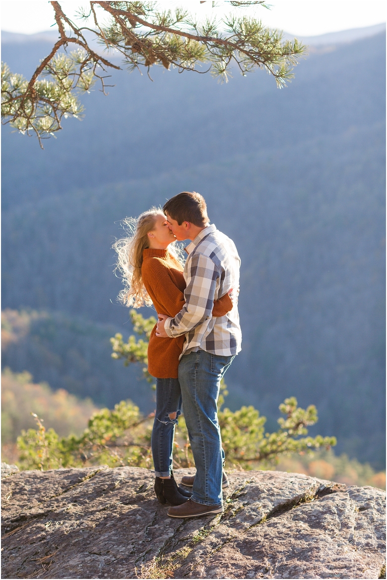 Blue Ridge engagement session with fall foliage and blue skies surrounding them.  Blue Ridge Parkway in Virginia. 