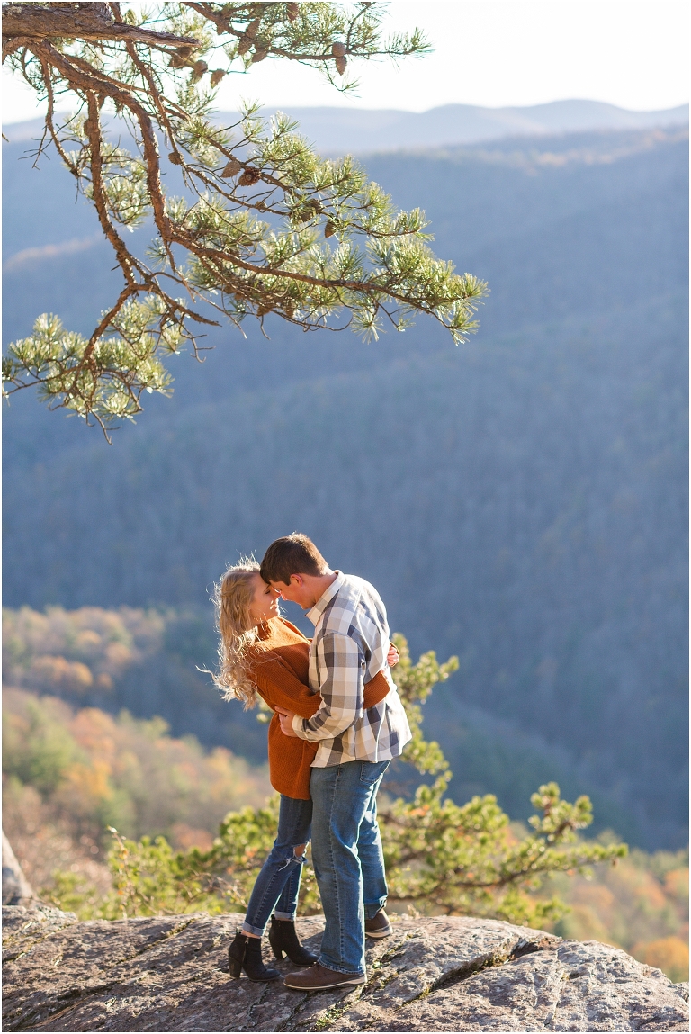 Blue Ridge engagement session with fall foliage and blue skies surrounding them.  Blue Ridge Parkway in Virginia. 