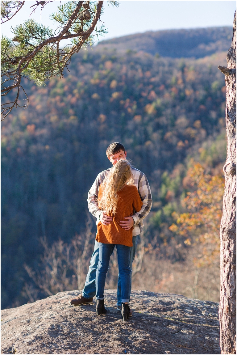 Blue Ridge engagement session with fall foliage and blue skies surrounding them.  Blue Ridge Parkway in Virginia. 