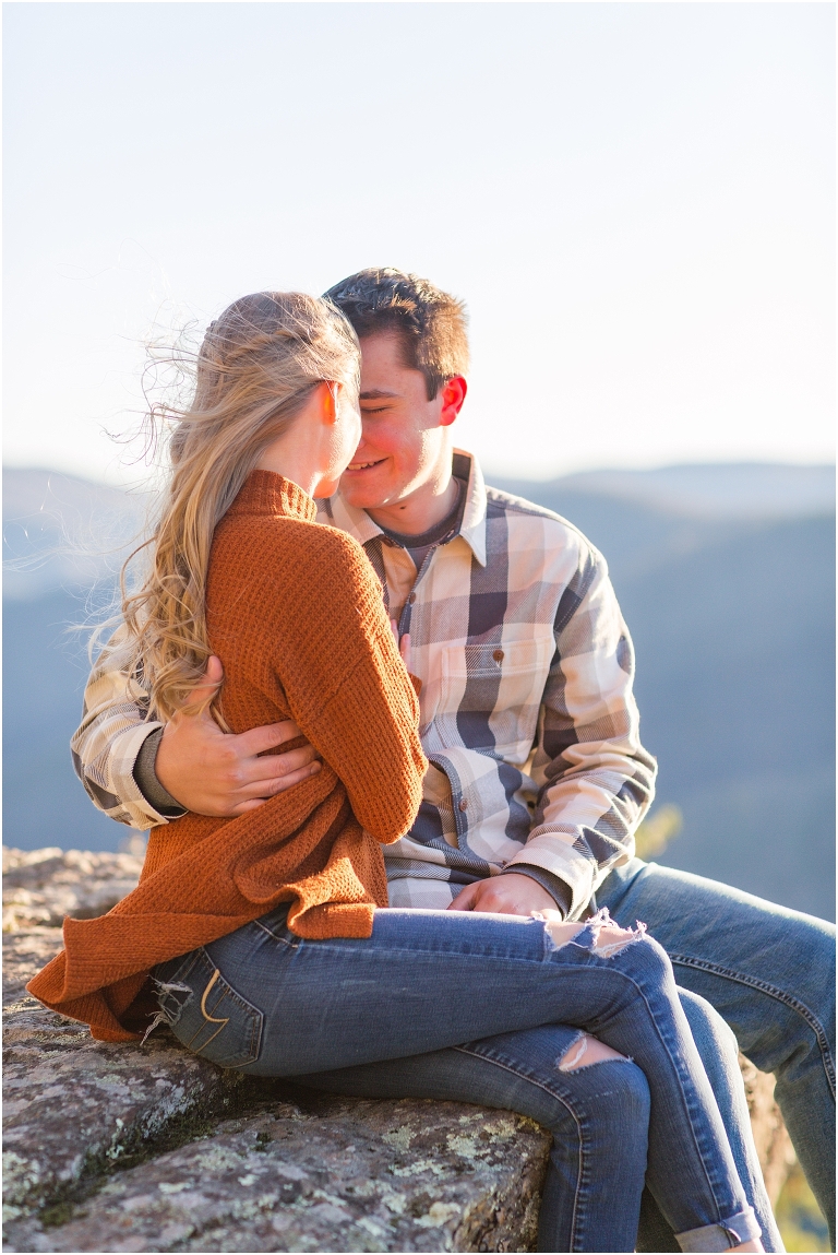 Blue Ridge engagement session with fall foliage and blue skies surrounding them.  Blue Ridge Parkway in Virginia. 