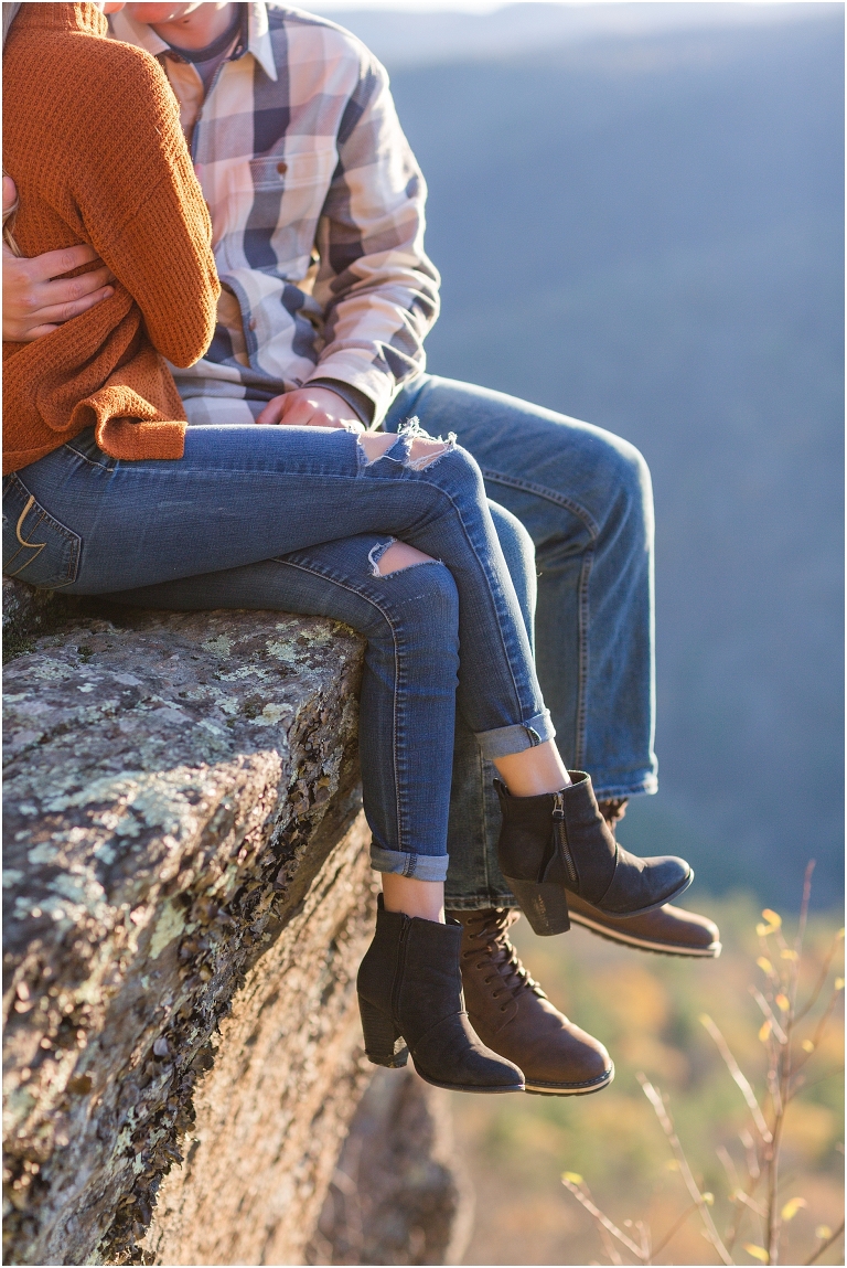 Blue Ridge engagement session with fall foliage and blue skies surrounding them.  Blue Ridge Parkway in Virginia. 