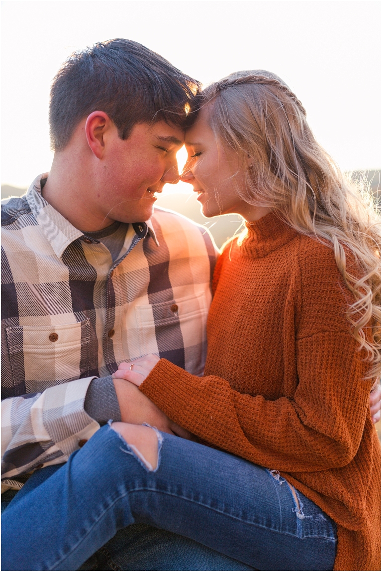 Blue Ridge engagement session with fall foliage and blue skies surrounding them.  Blue Ridge Parkway in Virginia. 