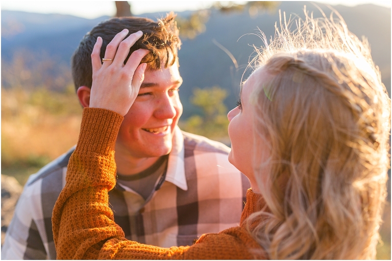 Blue Ridge engagement session with fall foliage and blue skies surrounding them.  Blue Ridge Parkway in Virginia. 