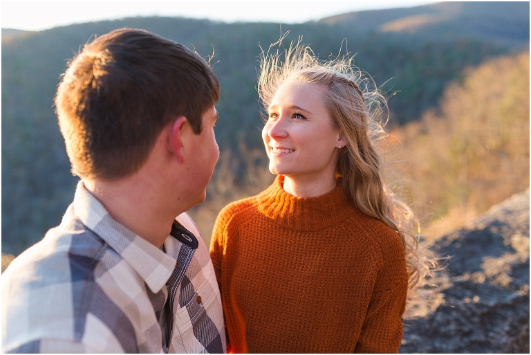Blue Ridge engagement session with fall foliage and blue skies surrounding them.  Blue Ridge Parkway in Virginia. 