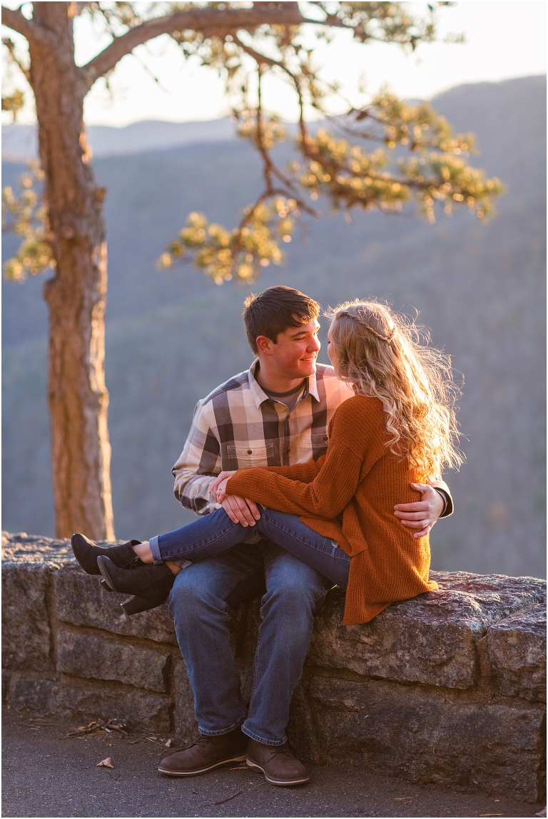 Blue Ridge engagement session with fall foliage and blue skies surrounding them.  Blue Ridge Parkway in Virginia. 