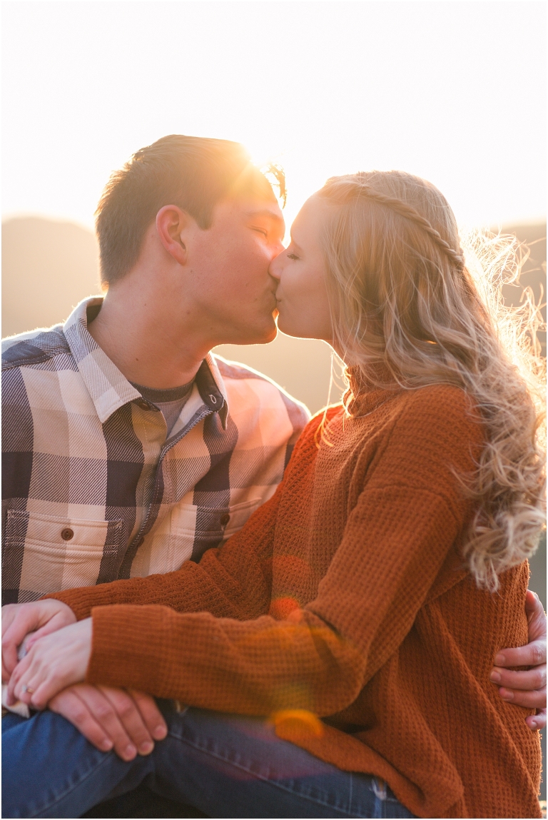 Blue Ridge engagement session with fall foliage and blue skies surrounding them.  Blue Ridge Parkway in Virginia. 