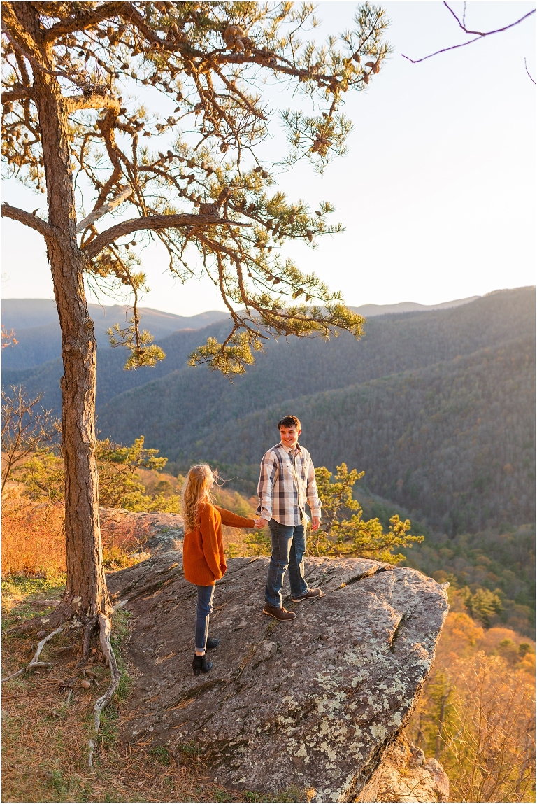 Blue Ridge engagement session with fall foliage and blue skies surrounding them.  Blue Ridge Parkway in Virginia. 