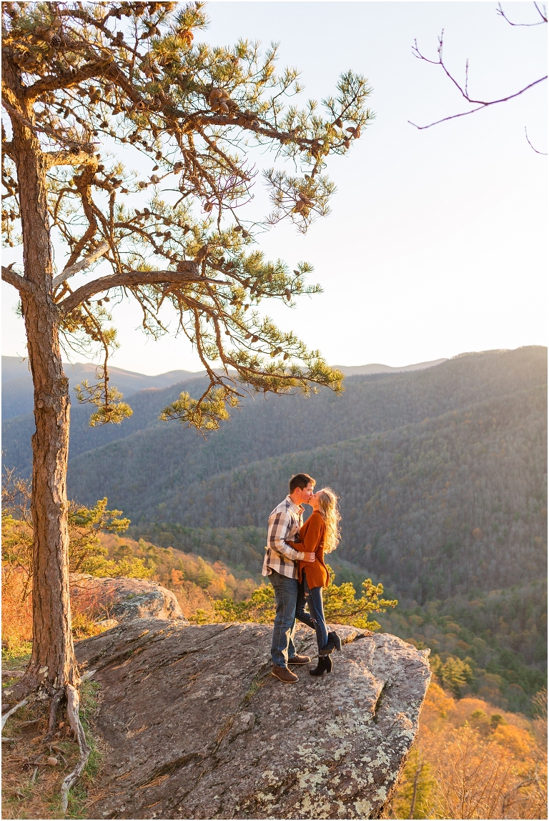 Blue Ridge engagement session with fall foliage and blue skies surrounding them.  Blue Ridge Parkway in Virginia. 