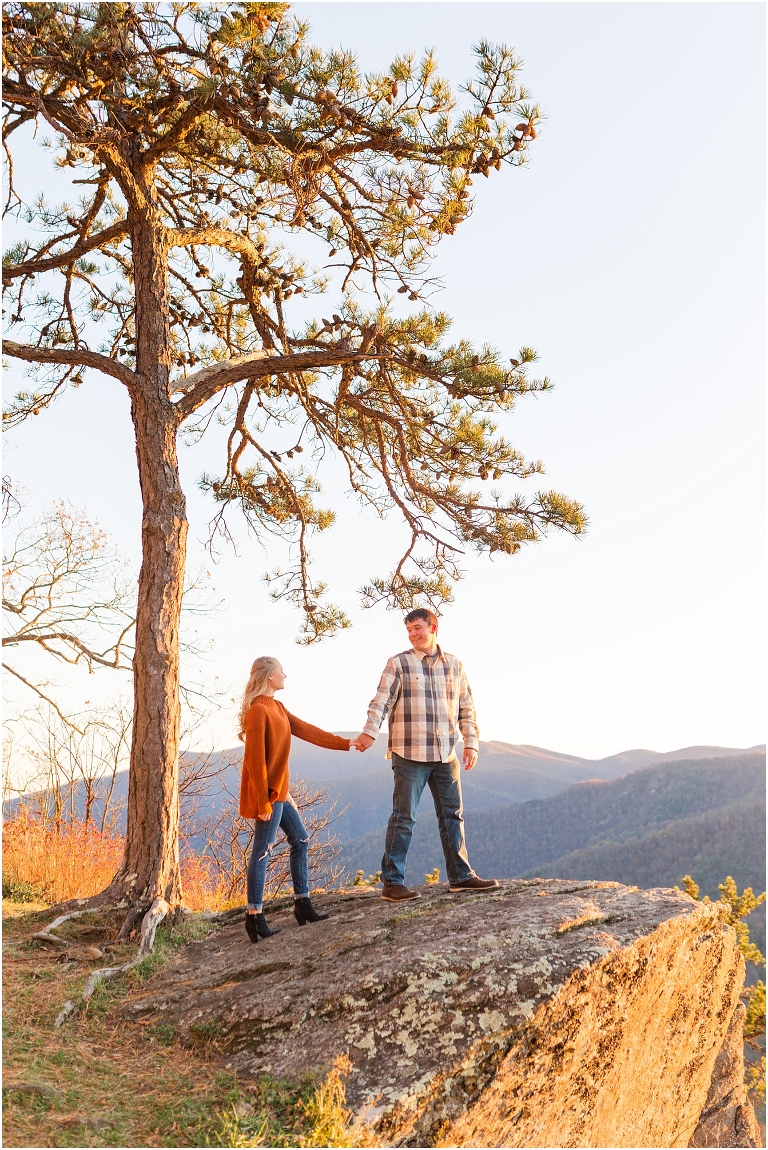 Blue Ridge engagement session with fall foliage and blue skies surrounding them.  Blue Ridge Parkway in Virginia. 