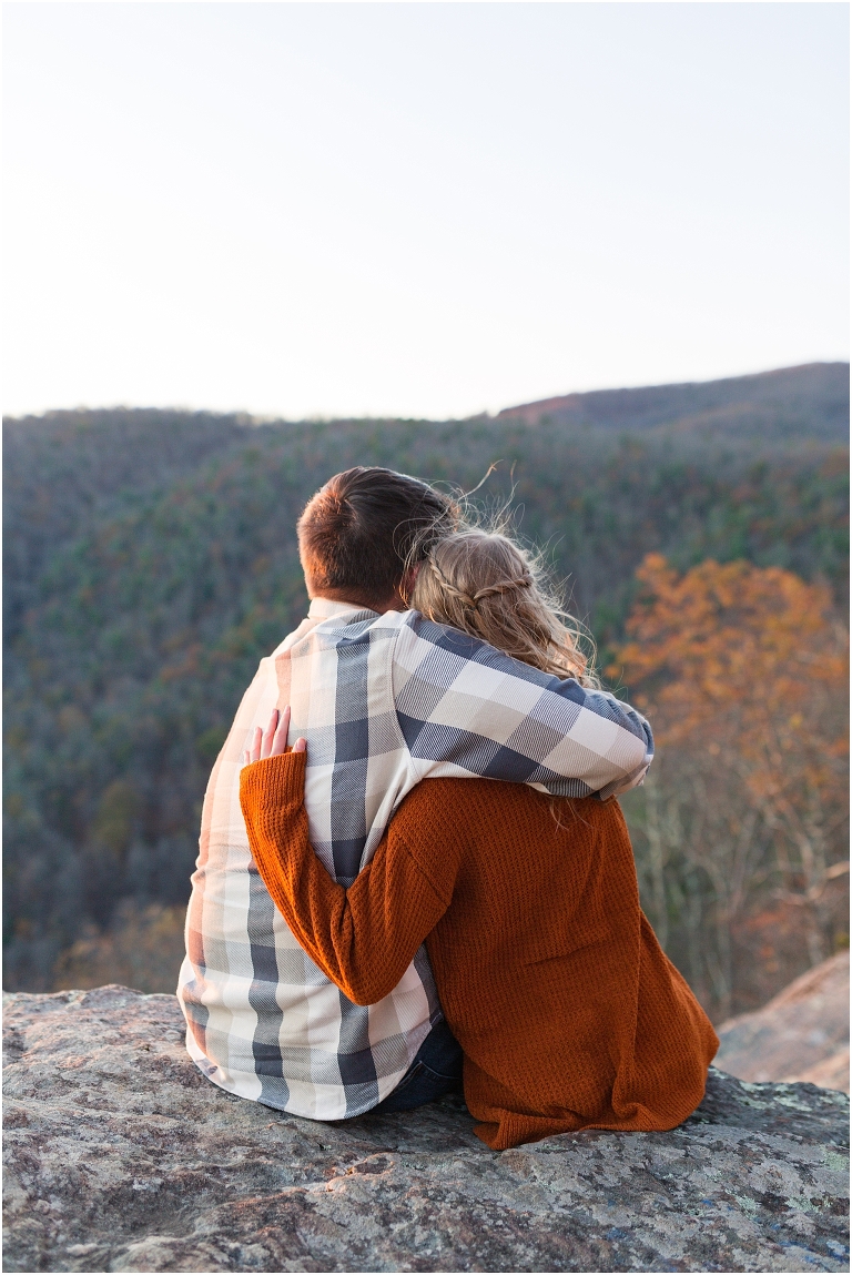 Blue Ridge engagement session with fall foliage and blue skies surrounding them.  Blue Ridge Parkway in Virginia. 