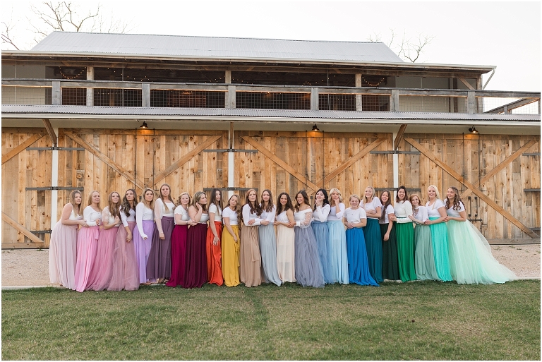 High school senior portraits with rainbow long skirts at a brown and white barn with a sunset mountain view in the Shenandoah Valley Virginia The Senior Giveback Project