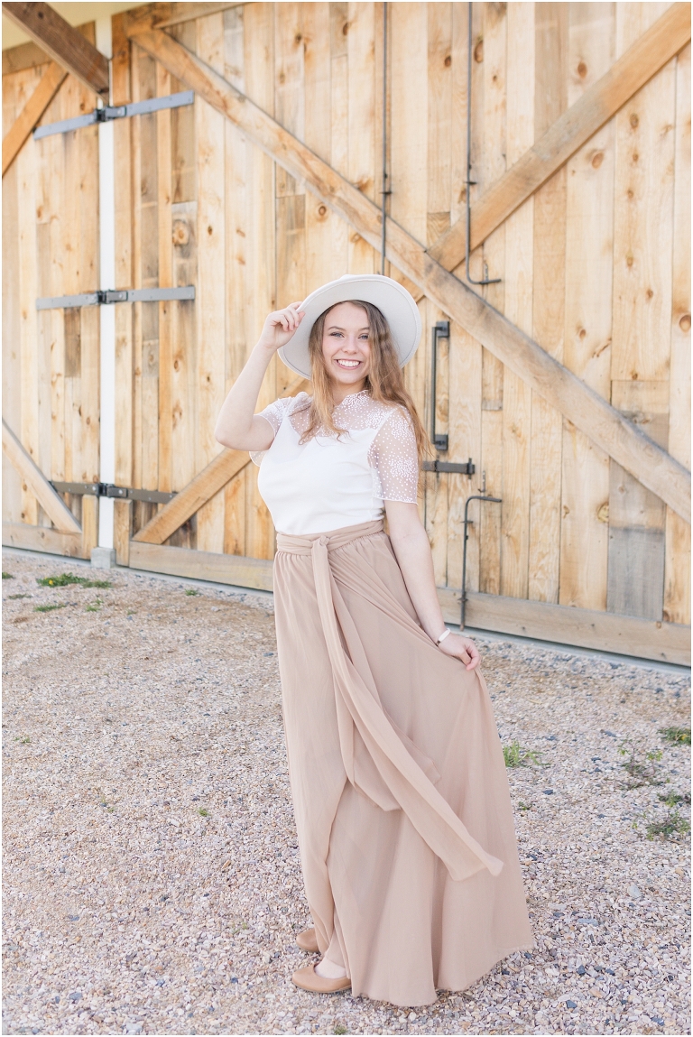 High school senior portraits with tan long skirt at a brown and white barn with a sunset mountain view in the Shenandoah Valley Virginia The Senior Giveback Project