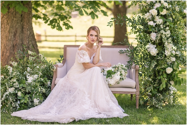 Romantic and classic garden manor wedding inspiration bridal portraits with a settee and floral instillations
