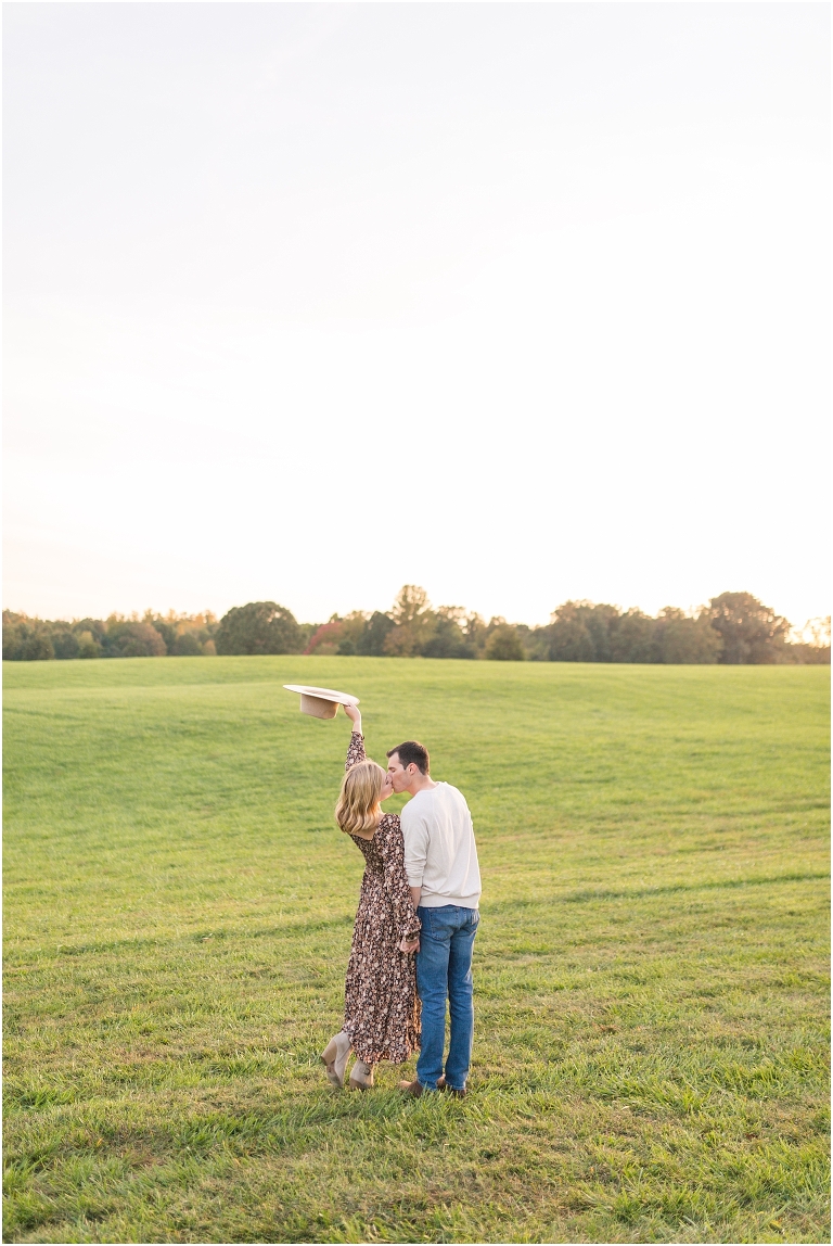 Autumn boho couples session in an open field during golden hour