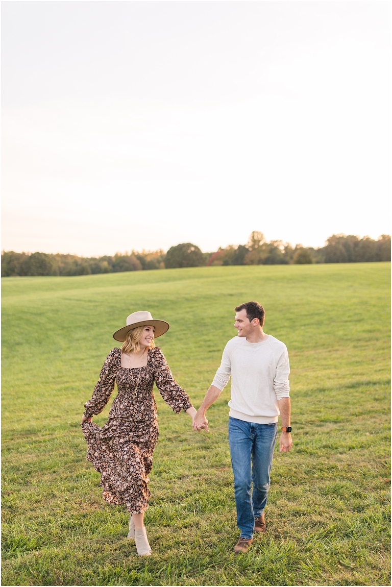 Autumn boho couples session in an open field during golden hour