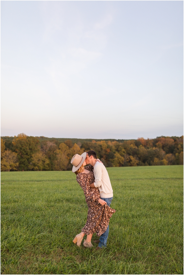 Autumn boho couples session in an open field during golden hour