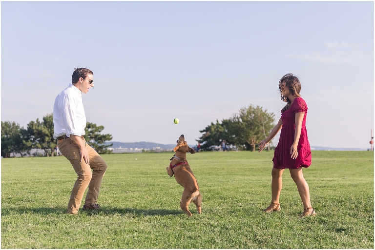 Gravelly Point Washington DC engagement session with their dog in an open field near the river during golden hour with planes flying overhead