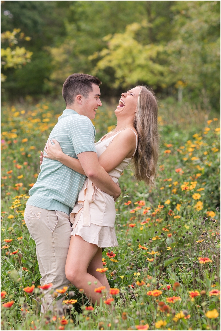 Purcell Park Harrisonburg Virginia spring couples session in a field of flowers and open grass field in a champagne dress