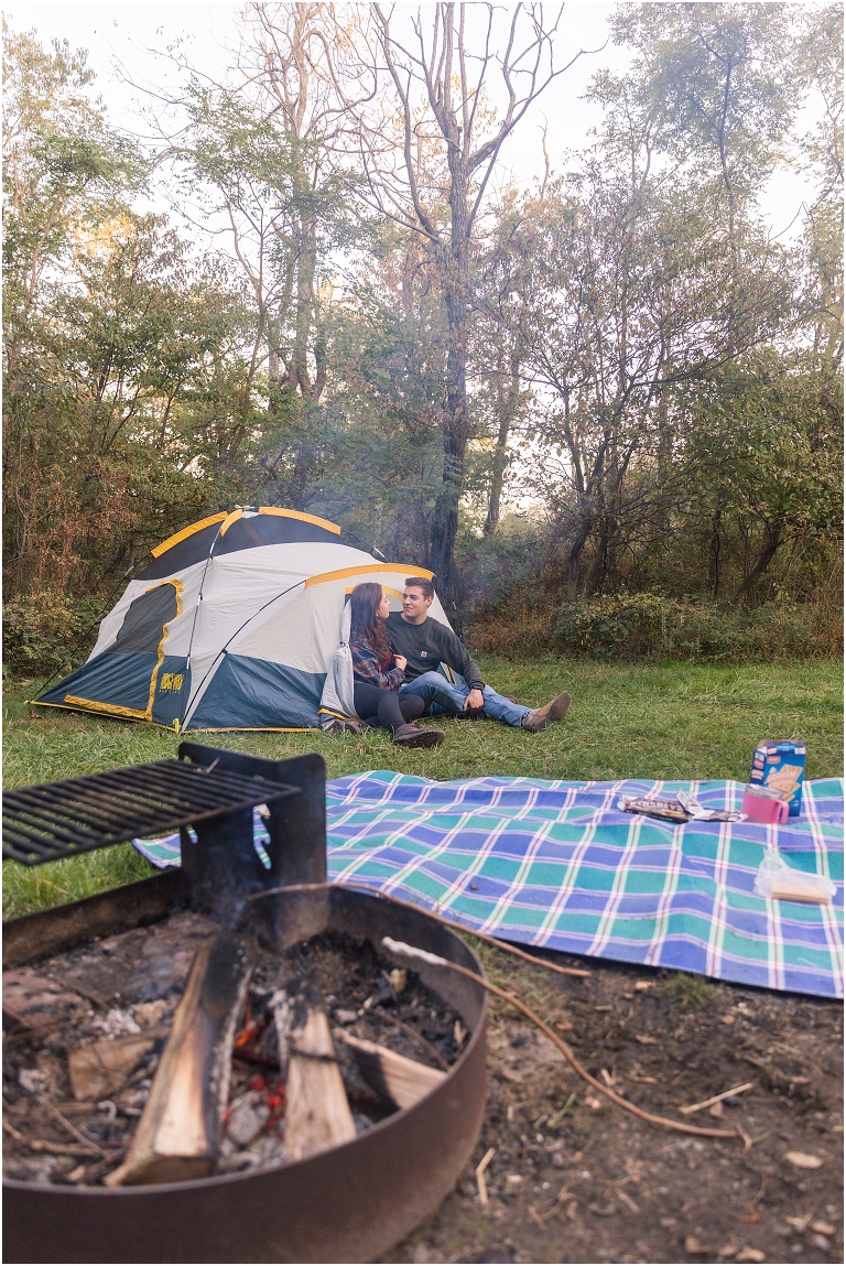 Couples camping session photos couple by a campfire in a tent in a campsite on Skyline Drive in Shenandoah National Park
