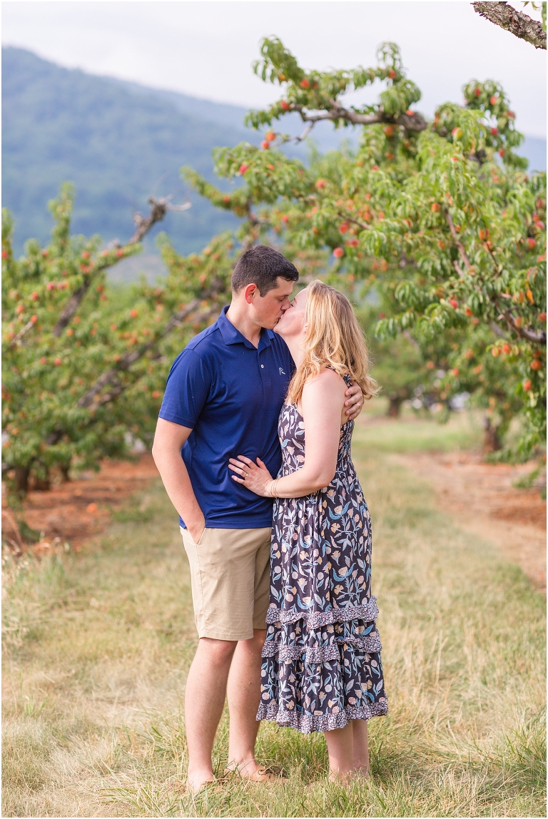 Couples portraits at an apple and peach orchard in Charlottesville Virginia with a mountain view