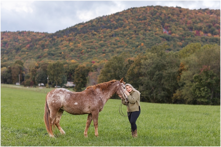 Autumn fall foliage senior horse portraits with a rust and white horse in an open field with a sunset mountain backdrop, Virginia senior graduation portrait photographer