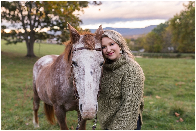 Autumn fall foliage senior horse portraits with a rust and white horse in an open field with a sunset mountain backdrop, Virginia senior graduation portrait photographer