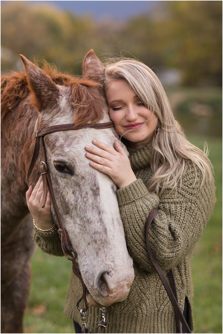 Autumn fall foliage senior horse portraits with a rust and white horse in an open field with a sunset mountain backdrop, Virginia senior graduation portrait photographer
