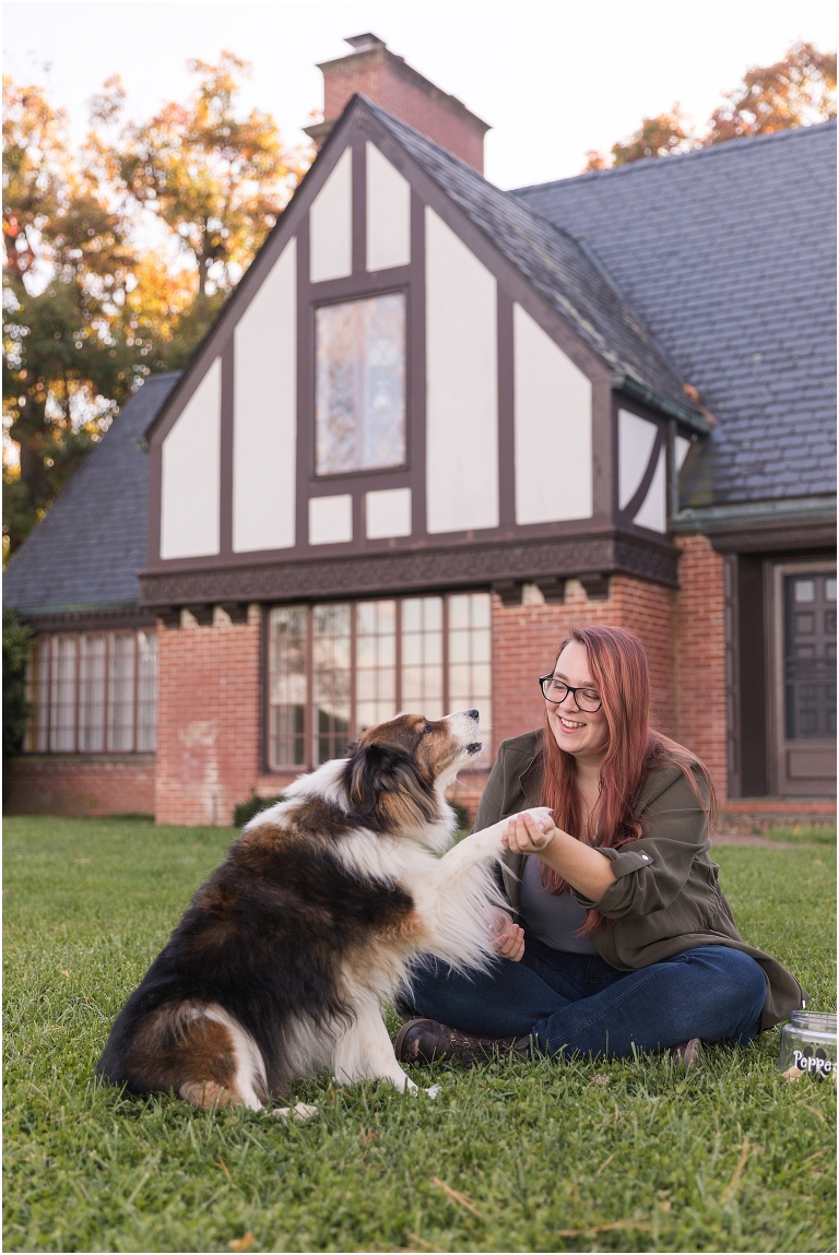 Autumn fall foliage senior with dog portraits in an open field with a sunset mountain backdrop and a Tudor manor, Virginia senior graduation portrait photographer