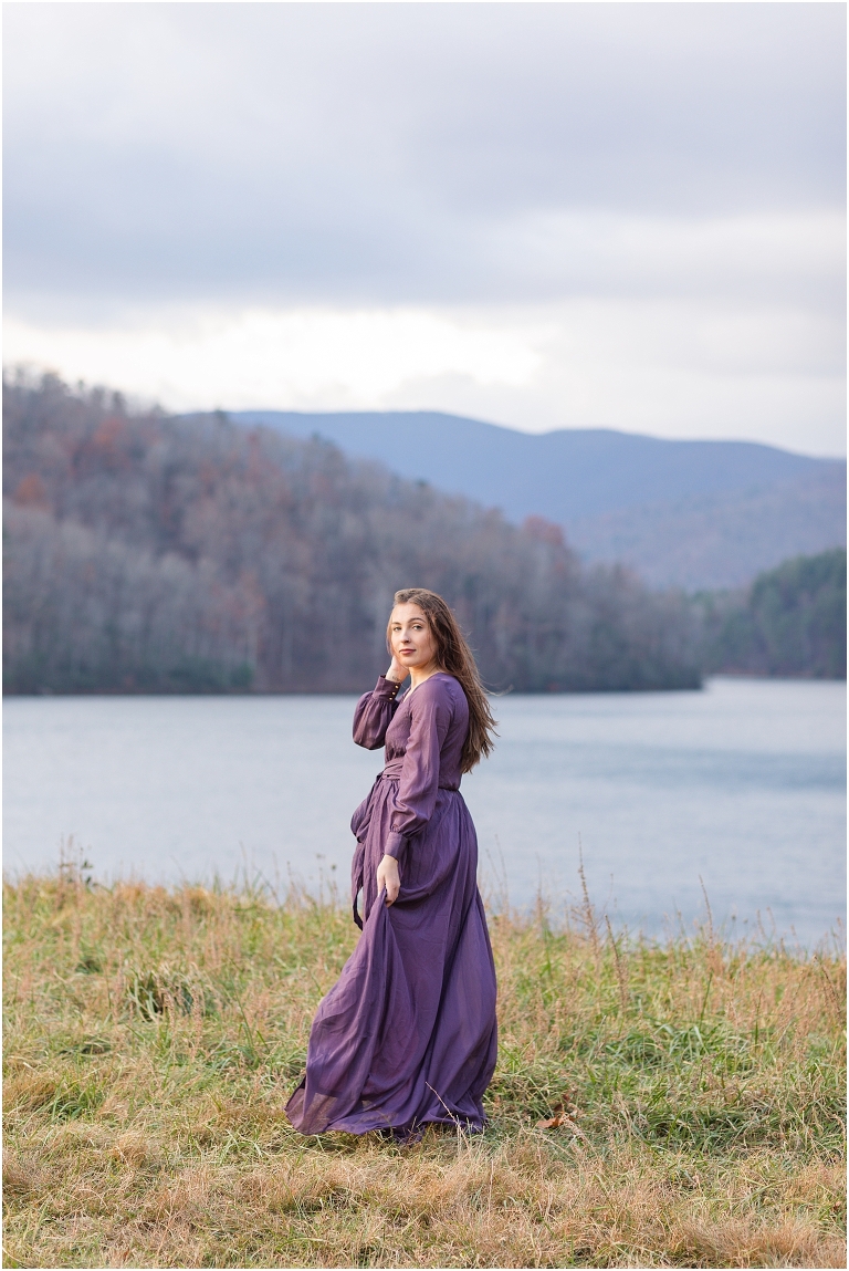 Senior portraits in a purple dress next to Switzer Lake with a mountain background at sunset, Virginia senior graduation portrait photographer