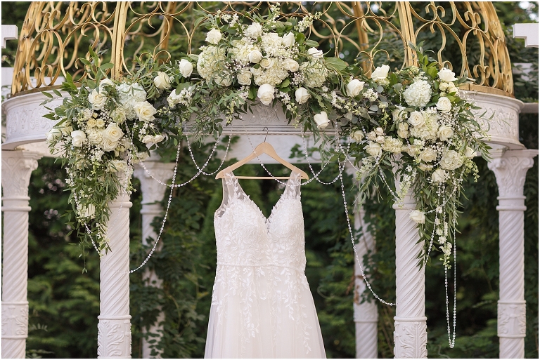 Lynn & TJ's classically beautiful wedding at The Bedford Columns in southwest Virginia with a gold and white gazebo decorated with green and white florals. Wedding dress photo