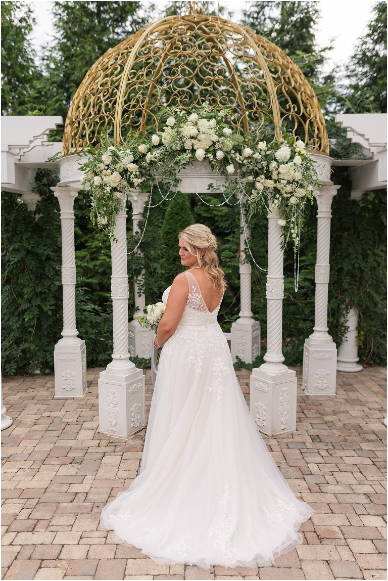 Lynn & TJ's classically beautiful wedding at The Bedford Columns in southwest Virginia with a gold and white gazebo decorated with green and white florals.