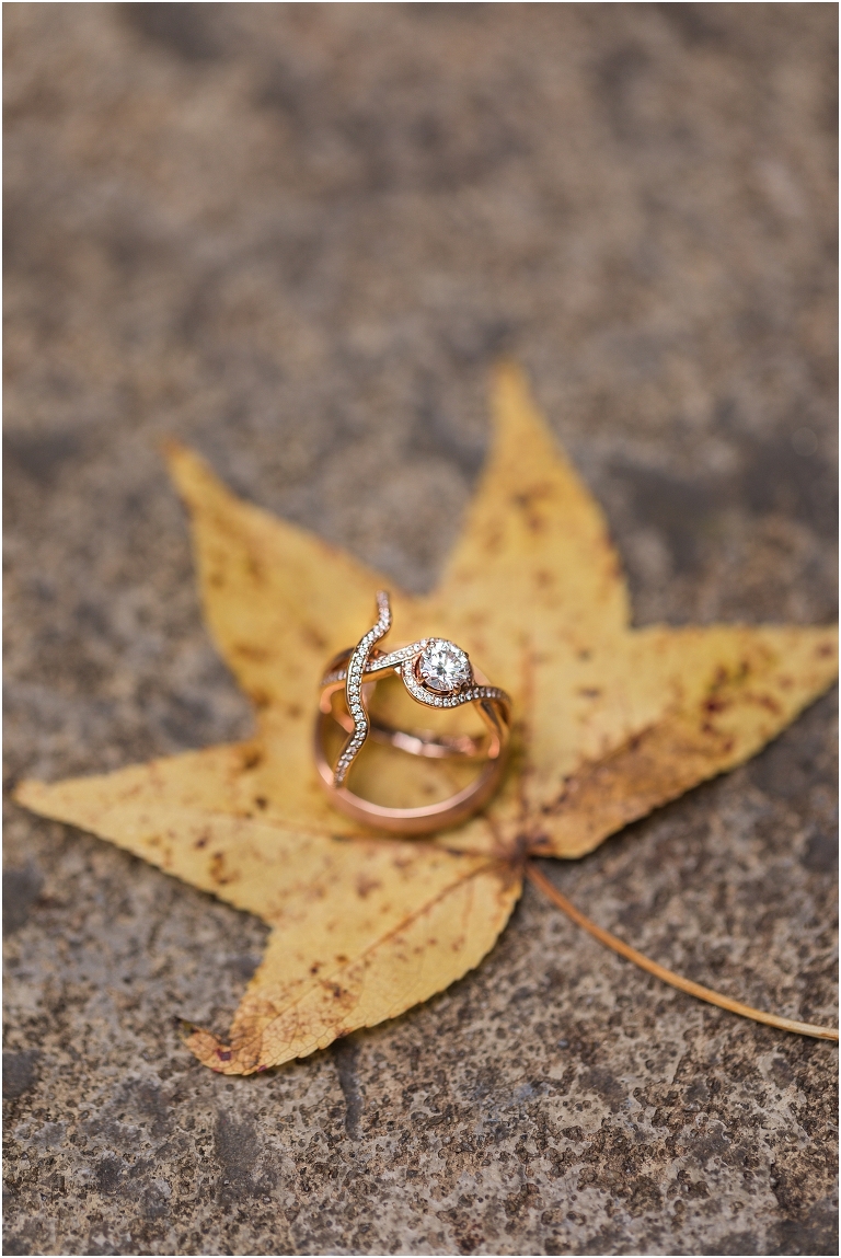 Emma & Dan's The Mill at Fine Creek Richmond autumn wedding with a riverside first look, ceremony in the garden surrounded by fall foliage, and portraits in the fairy light lit abandoned mill at dusk. This is a closeup ring shot on an autumn leaf.