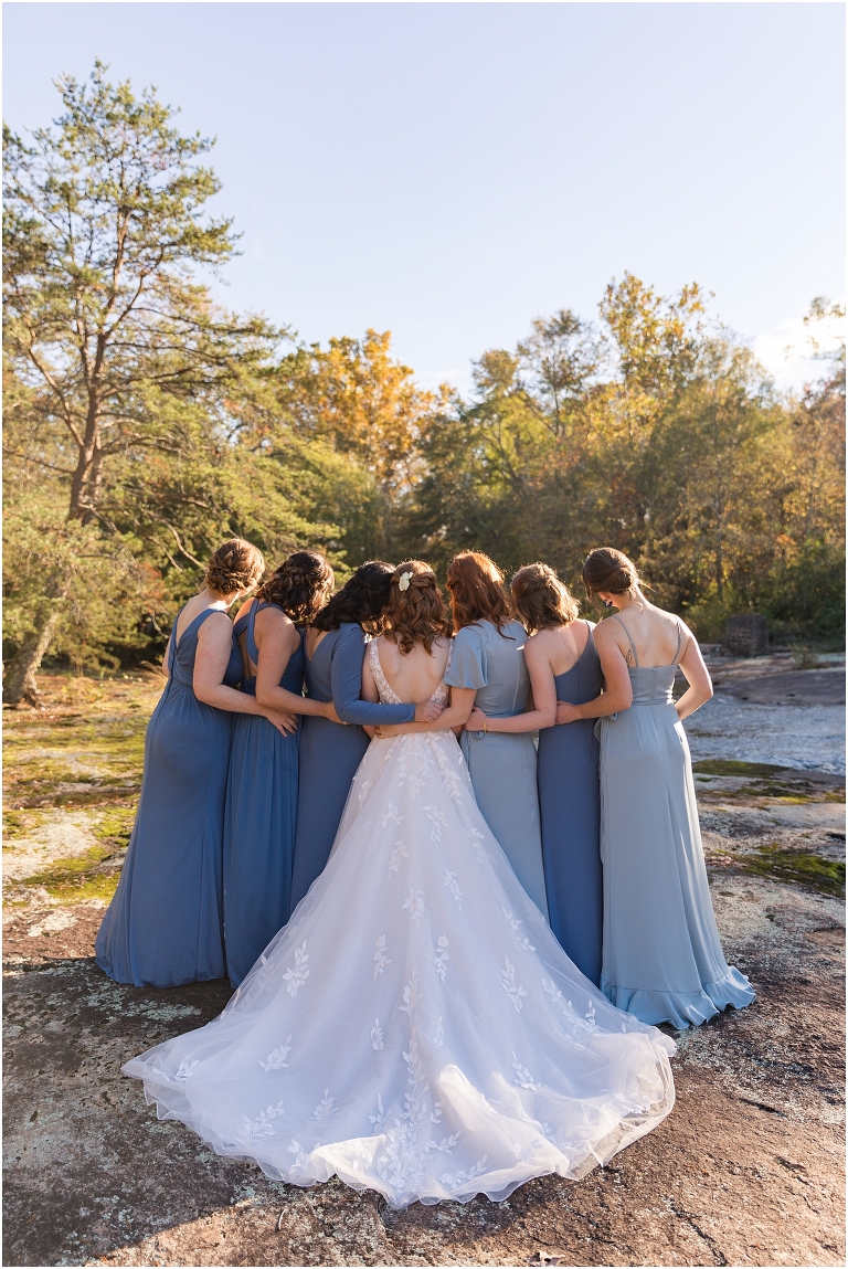 Emma & Dan's The Mill at Fine Creek Richmond autumn wedding with a riverside first look, ceremony in the garden surrounded by fall foliage, and portraits in the fairy light lit abandoned mill at dusk. Blue bridesmaid dresses photo