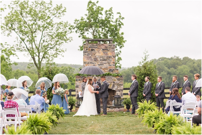 Abby & Travis's rainy wedding at Red August Farm in the Shenandoah Valley, Virginia with clear umbrella wedding portraits and a sparkler exit.