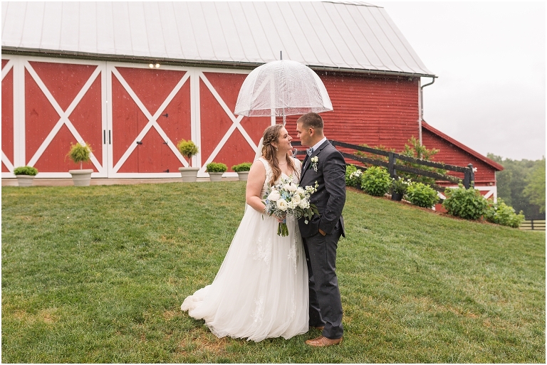 Abby & Travis's rainy wedding at Red August Farm in the Shenandoah Valley, Virginia with clear umbrella wedding portraits and a sparkler exit.
