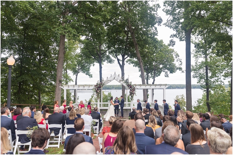 Allie & Cam's autumn riverside Richmond wedding at Celebrations at the Reservoir with a first dance under the lights, forest newlywed portraits, a dessert table, and a signature drink named after their dog.