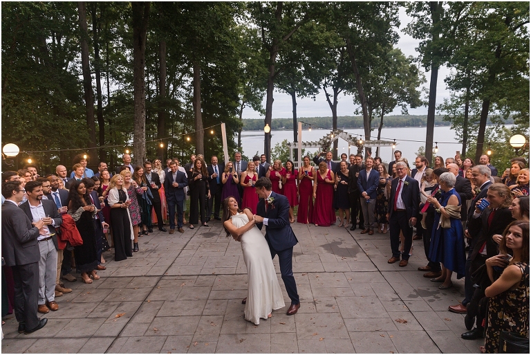 Allie & Cam's autumn riverside Richmond wedding at Celebrations at the Reservoir with a first dance under the lights, forest newlywed portraits, a dessert table, and a signature drink named after their dog.